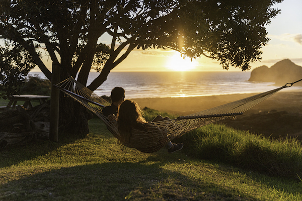 Couple in hammock by Auckland beach