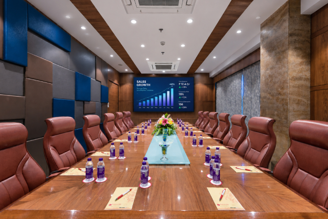 Boardroom in Nashik with executive seating, conference table, 
presentation screen, water bottles and a professional corporate meeting setup